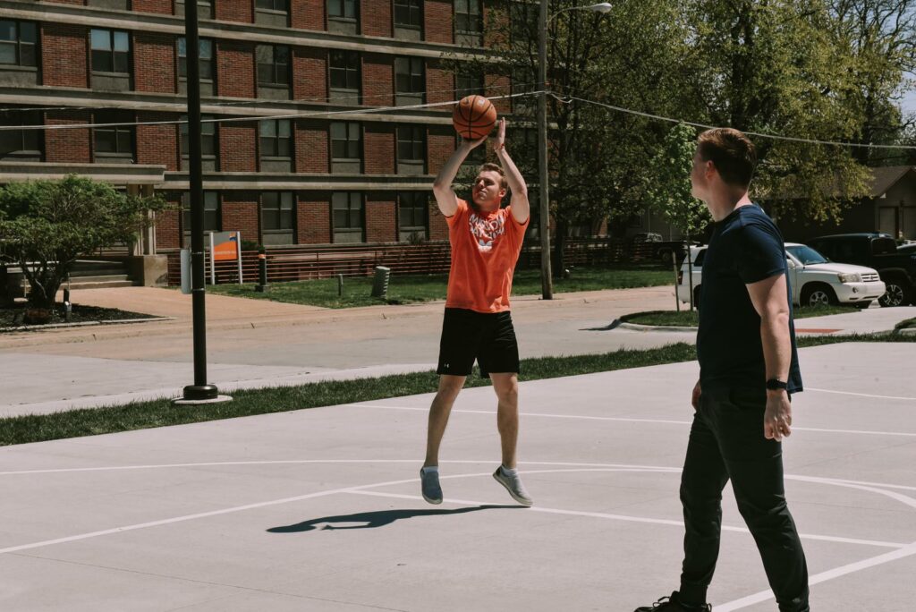 Midland University student playing basketball at Miller Hall