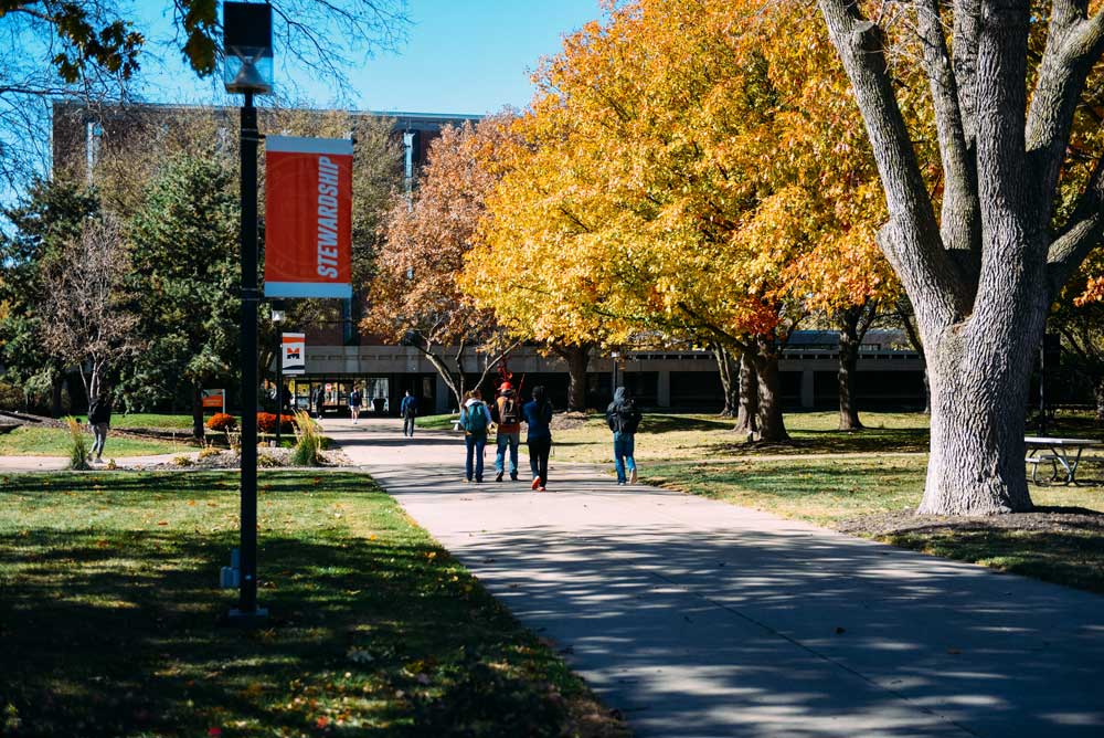 Students Walking Across Campus in Fall