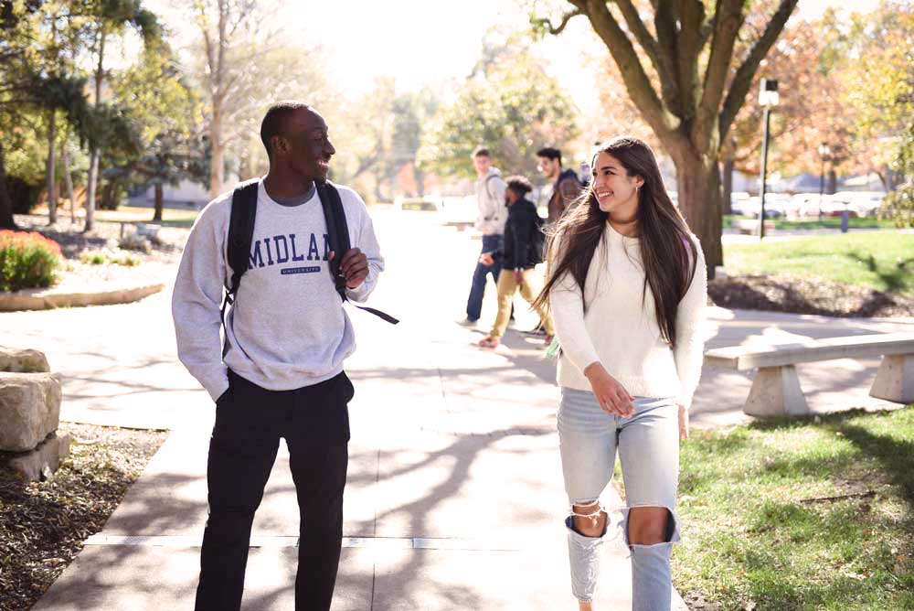 Midland University Students Walking Across Campus