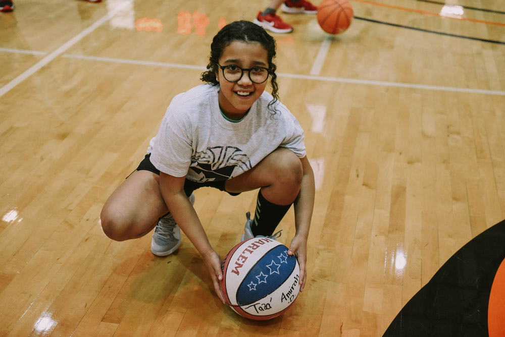 Midland University Team Jack Basketball Clinic Participant with Basketball